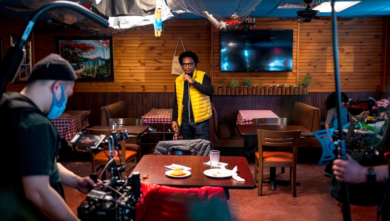 A film crew sets up for filming inside a restaurant