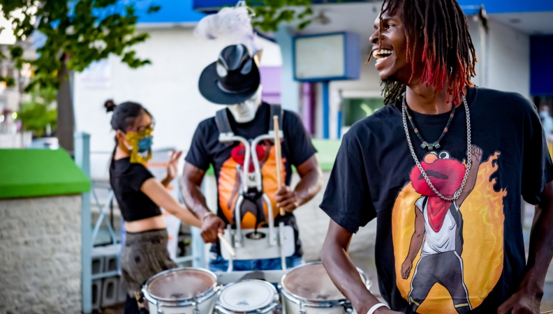 three members of a Philly drumline dancing and performing