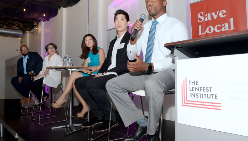 a seated man speaking during a five person panel at the Lenfest Institute