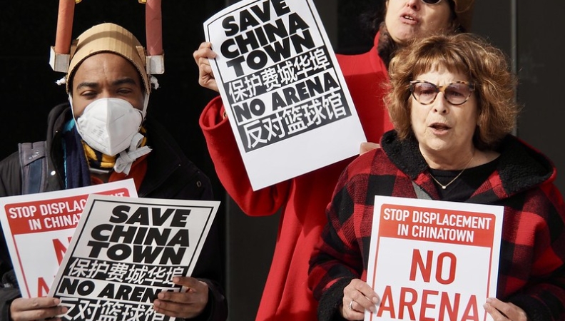 three protesters holding signs that read "Save Chinatown" and "No Arena"