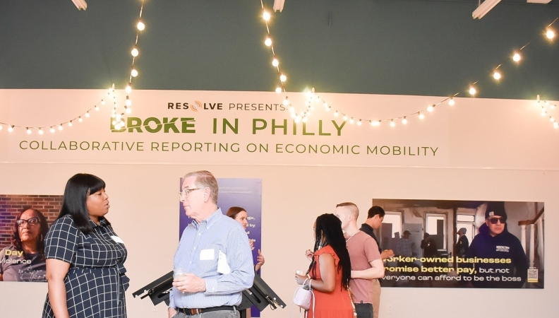 two people chatting at a journalism project exhibit