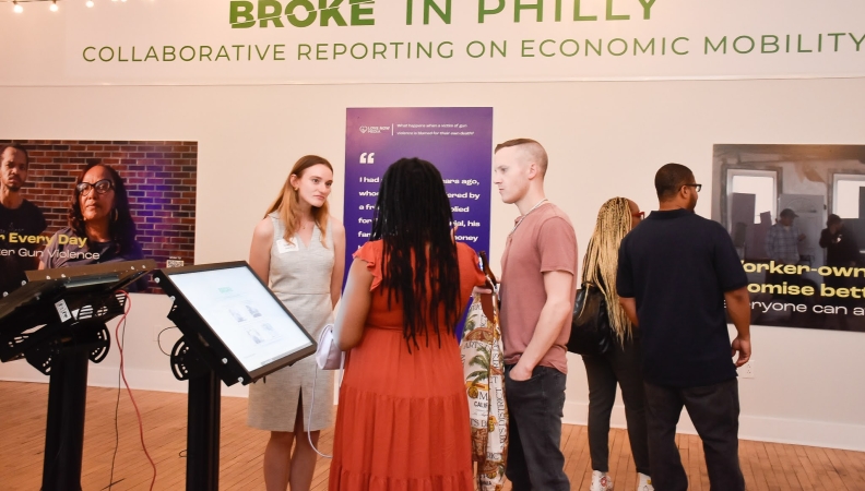 a group of people at a solutions journalism exhibition