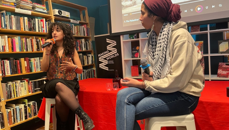 a post film screening interview with two people sitting on chairs at the front of a room