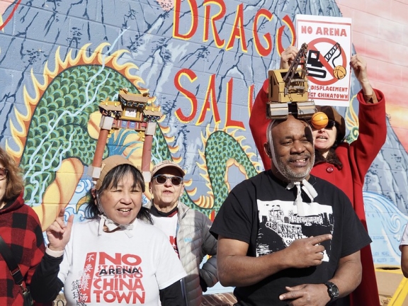a group of protesters gathered in Philadelphia's Chinatown holding 'no arena' posters