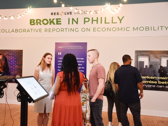 a group of people at a solutions journalism exhibition