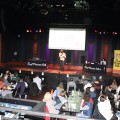 A person speaks to a crowd at the World Cafe Live