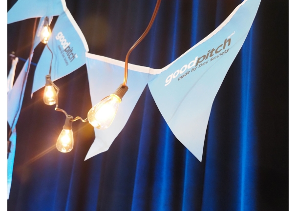 stringed pennants hanging behind a string of light bulbs